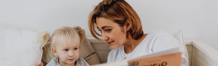 mother reading a book with child